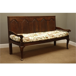  George III oak settle, the back with five raised and fielded panels and shaped arms, on cabriole legs with pad feet, the loose seat cushion embroidered with scrolling foliage, W183cm, H102cm, D69cm  