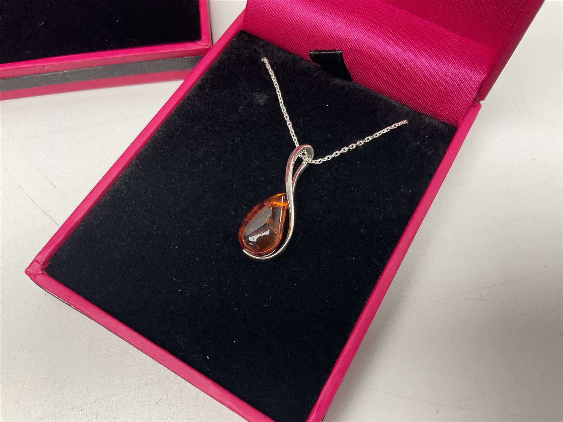 Six silver Baltic amber pendant necklaces, including dinosaur and butterfly designs, all stamped 925 