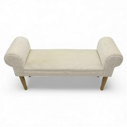Contemporary upholstered window seat, rectangular padded seat with shallow scroll ends, upholstered in light cream fabric, raised on four turned wooden supports