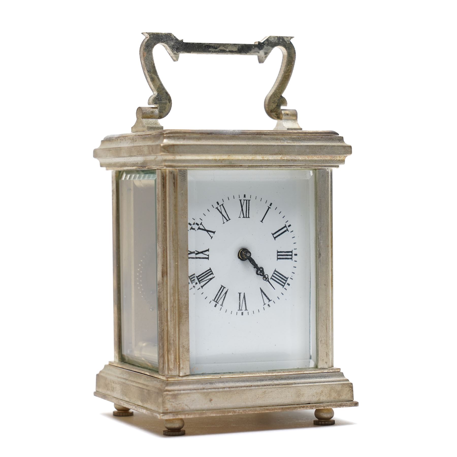 20th century- Silver plated miniature carriage clock in an anglaise case with an enamel dial, Roman numerals, minute track and pieced steel hands, with an oval viewing glass to the lever platform escapement.