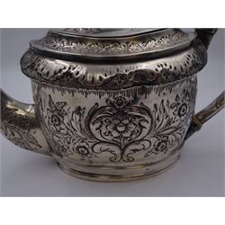 George III silver teapot, of oval form, with embossed foliate, floral and scroll decoration and engraved central cartouche, with acanthus capped C handle with ivory insulators, hallmarked John Emes, London 1807 This item has been registered for sale under Section 10 of the APHA Ivory Act
