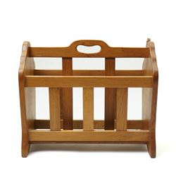 Squirrelman - oak magazine rack, the shaped ends enclosing a central slatted support with carrying aperture, enclosed by slatted sides and base, with carved squirrel signature, by Wilfrid Hutchinson of Husthwaite