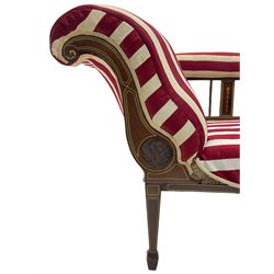 Edwardian inlaid rosewood and mahogany chaise longue, the serpentine back carved with floral roundel, upholstered in stripe fabric, square tapering supports with spade feet