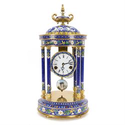20th century- 8-day cloisonne styled rotunda clock, with six decorative enamel pillars and floral decoration to the base and top, visible pendulum with a portrait depiction of a young lady, four inch enamel dial with Roman numerals, minute markers and trefoil steel hands, twin train spring driven rack striking movement sounding the hours and half hours on a coiled gong.   