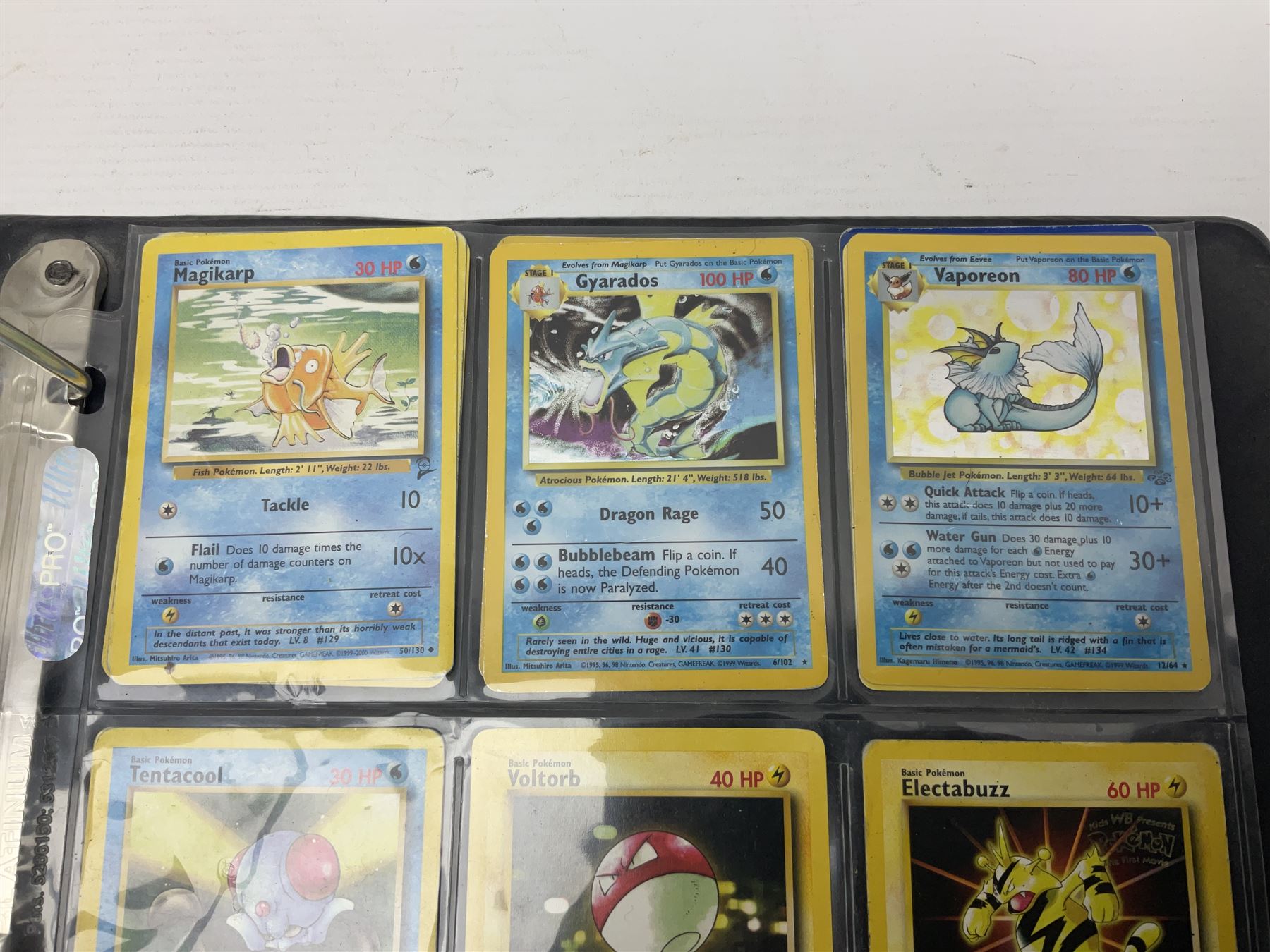 Collection of Pokemon trading cards, mostly 1999 Wizards Pokemon cards to include holo Charizard 4/102, first edition holo Machamp 8/102, further holographic cards; Dark Flareon 35/82 and Dark Vaporeon 45/82, cards from themed sets and 4th edition prints; 1998 Electronic Pokédex with cardboard boxes for themed decks Blackout, Overgrowth and Power Reserve Jungle, along with a large quantity of energy and trainer cards 