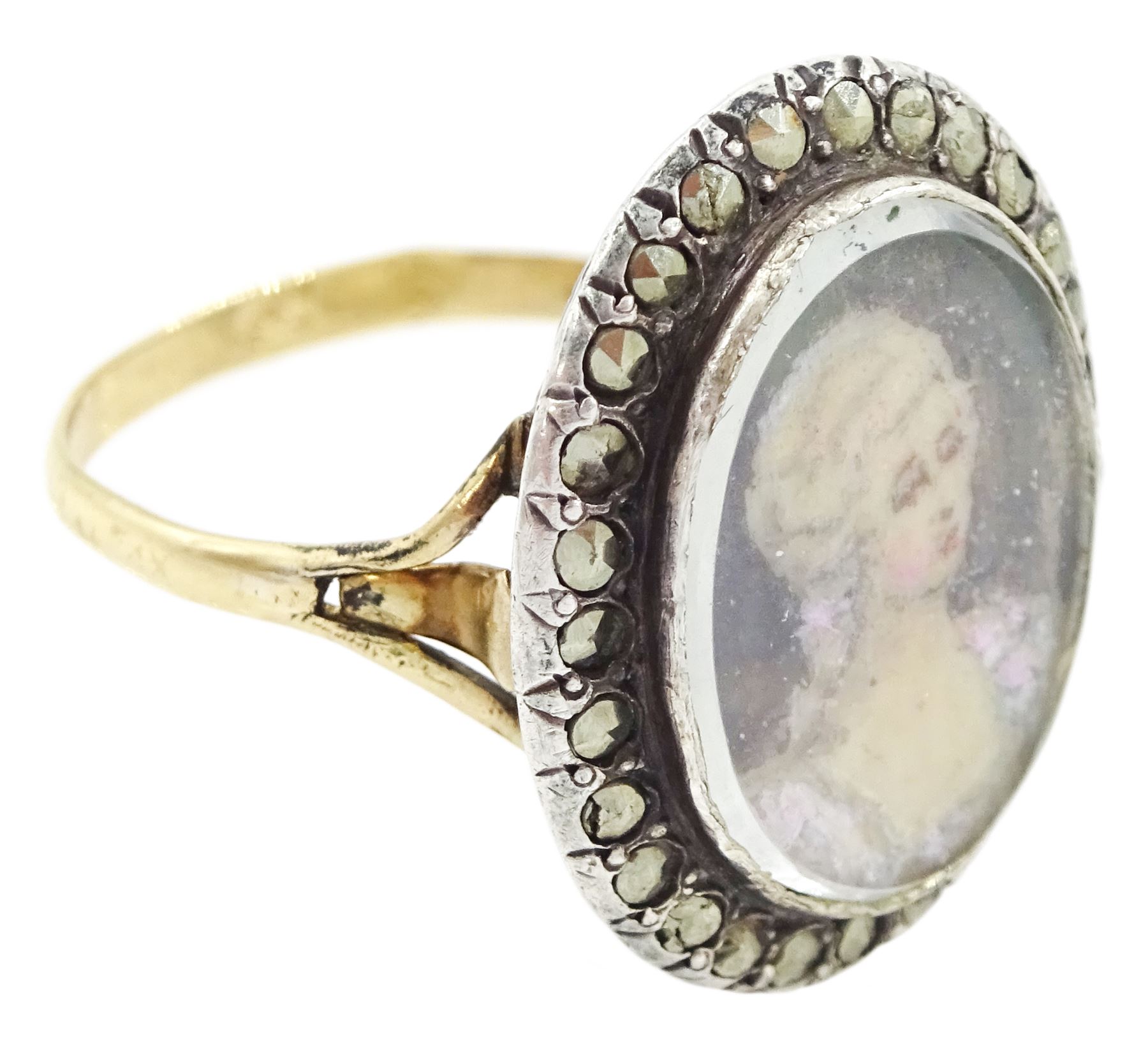 19th century French 18ct gold and silver marcasite portrait ring, set with an oval miniature of a woman on ivory, under glazed panel, with marcasite surround and trifurcated shoulders, hallmarked. This lot has been registered for sale under Section 10 of the APHA Ivory Act