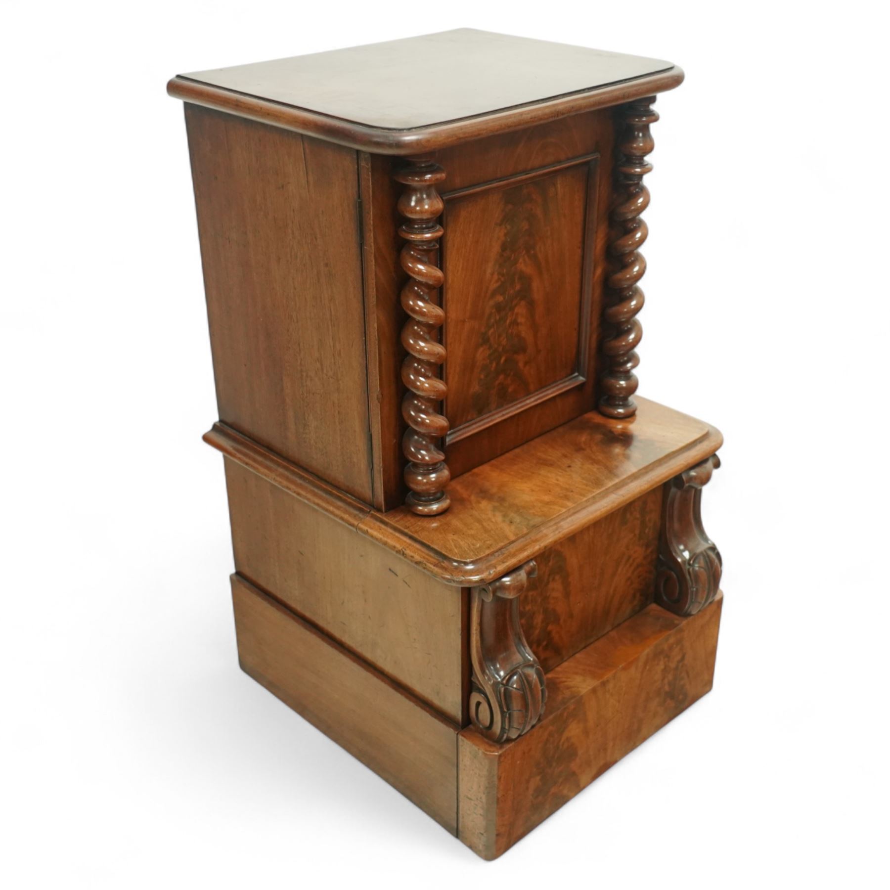 Victorian figured mahogany commode with enclosed bidet, upper cupboard with barley twist supports above sliding and hinged seat elements with leather panels, on plain plinth base