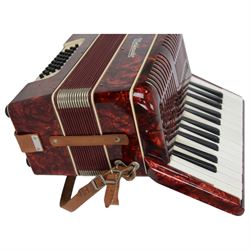 World master piano accordion with  14 fold bellows, two octave keyboard and 32 buttons. With a hard carrying case.