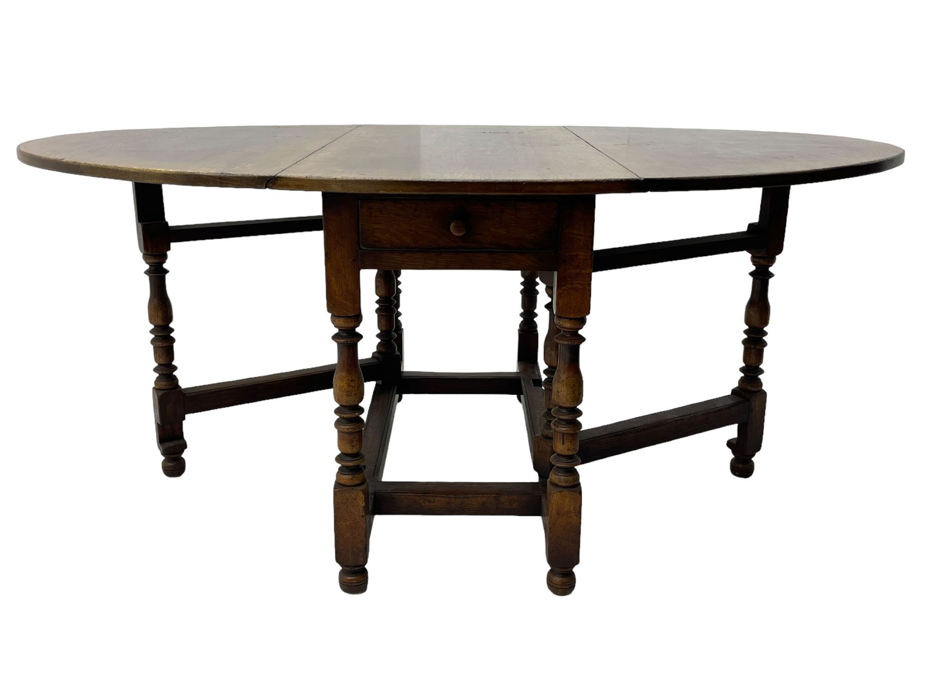 19th century oak dining table, oval drop-leaf top on gate-leg action base, turned supports united by turned stretchers, fitted with single end drawer