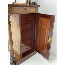 Early Victorian figured mahogany dressing cabinet, the raised shell and scroll carved back lifts to reveal rectangular easel mirror with mahogany band, flat rectangular top with tooled leather inset, slide at each side with matching leather inset, full width drawer above cupboard enclosing a series of five drawers, turned front supports, panelled front, sides and back