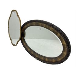 Shaped gilt framed wall mirror decorated with shell motifs (61cm x 45cm); and an oval framed wall mirror (79cm x 51cm)