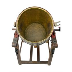 19th century oak and cast iron rotary butter churn, with coopered barrel body, domed lid with filler opening and cast iron securing arms, on tilting iron-mounted frame with crank handle and support rails