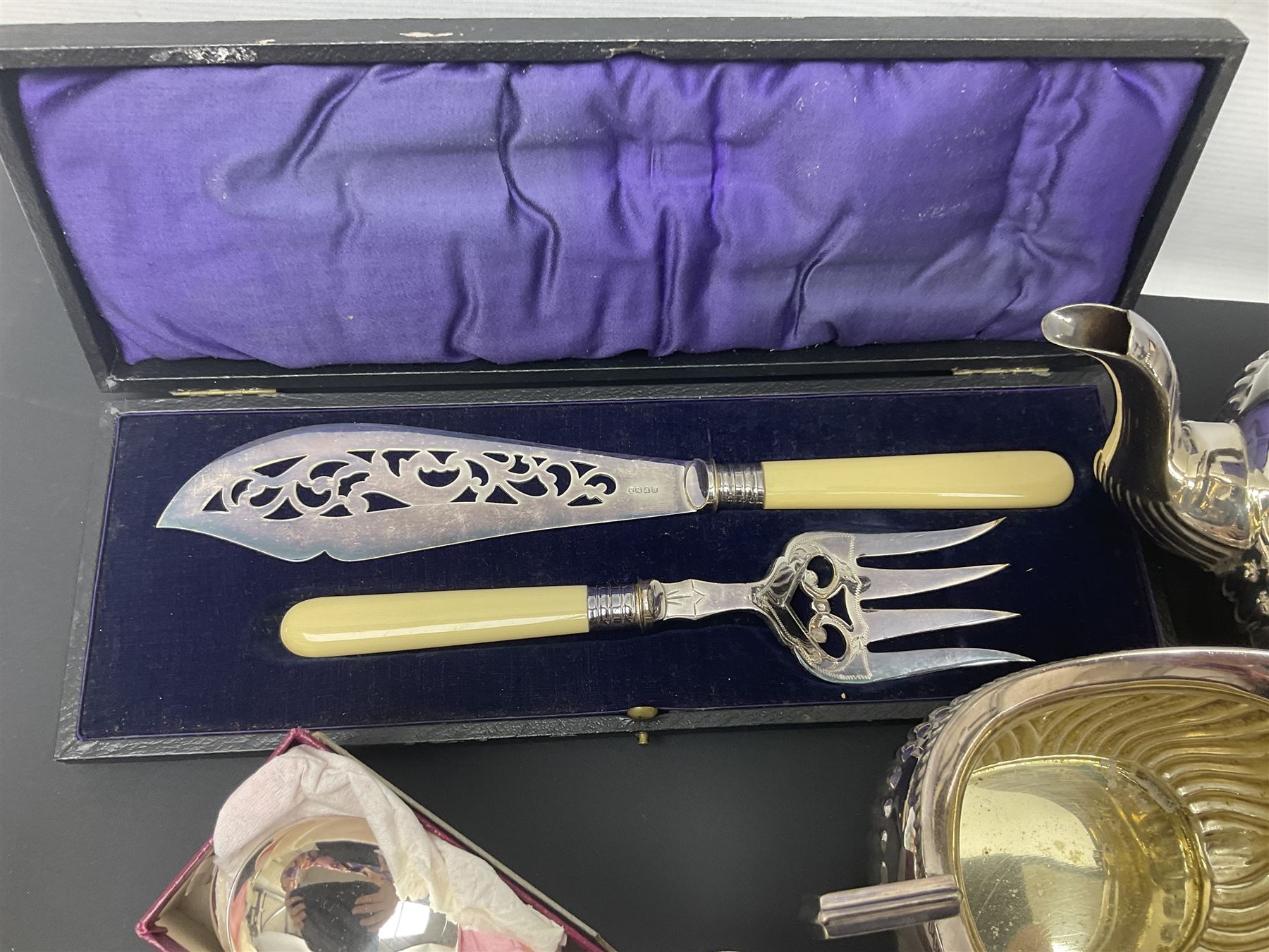 Mother of Pearl handled cutlery, with silver ferrules, comprising six fish knives and forks and six fruit knives and forks, the ferrules hallmarked Yates Brothers, Sheffield 1905, together with silver plated Edwardian three piece tea service and other flatware 