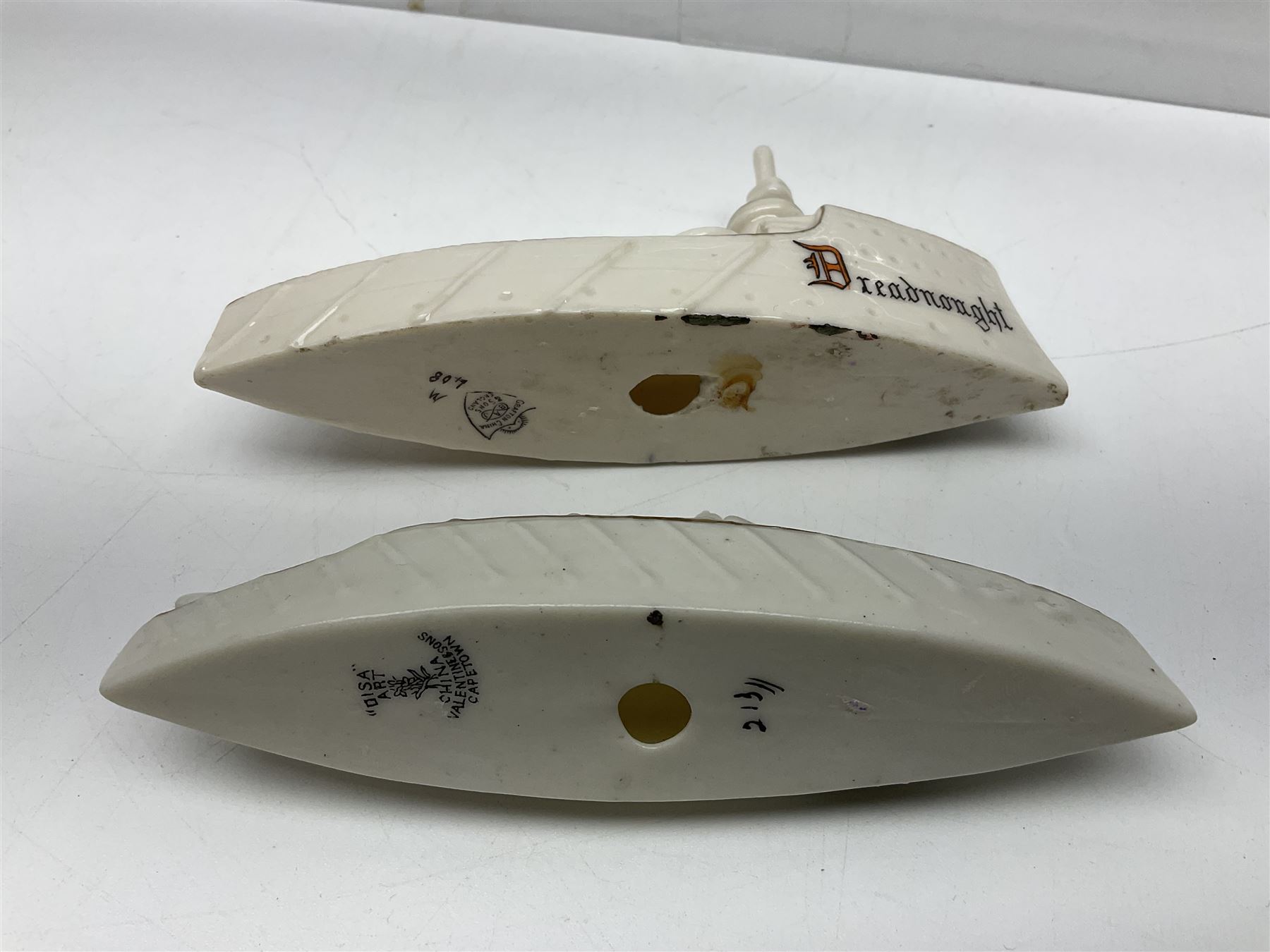 Ten WW1 crested china military models comprising submarine, four ships including Lusitania, four Zeppelins/balloons and an aircraft; various makers including Arcadian China, Swan China, Carlton China, Waterfall, Grafton China etc; various crests including Saint Neots, Great Yarmouth, Tewksbury, Swanage, Simons Town, Hull etc (10)