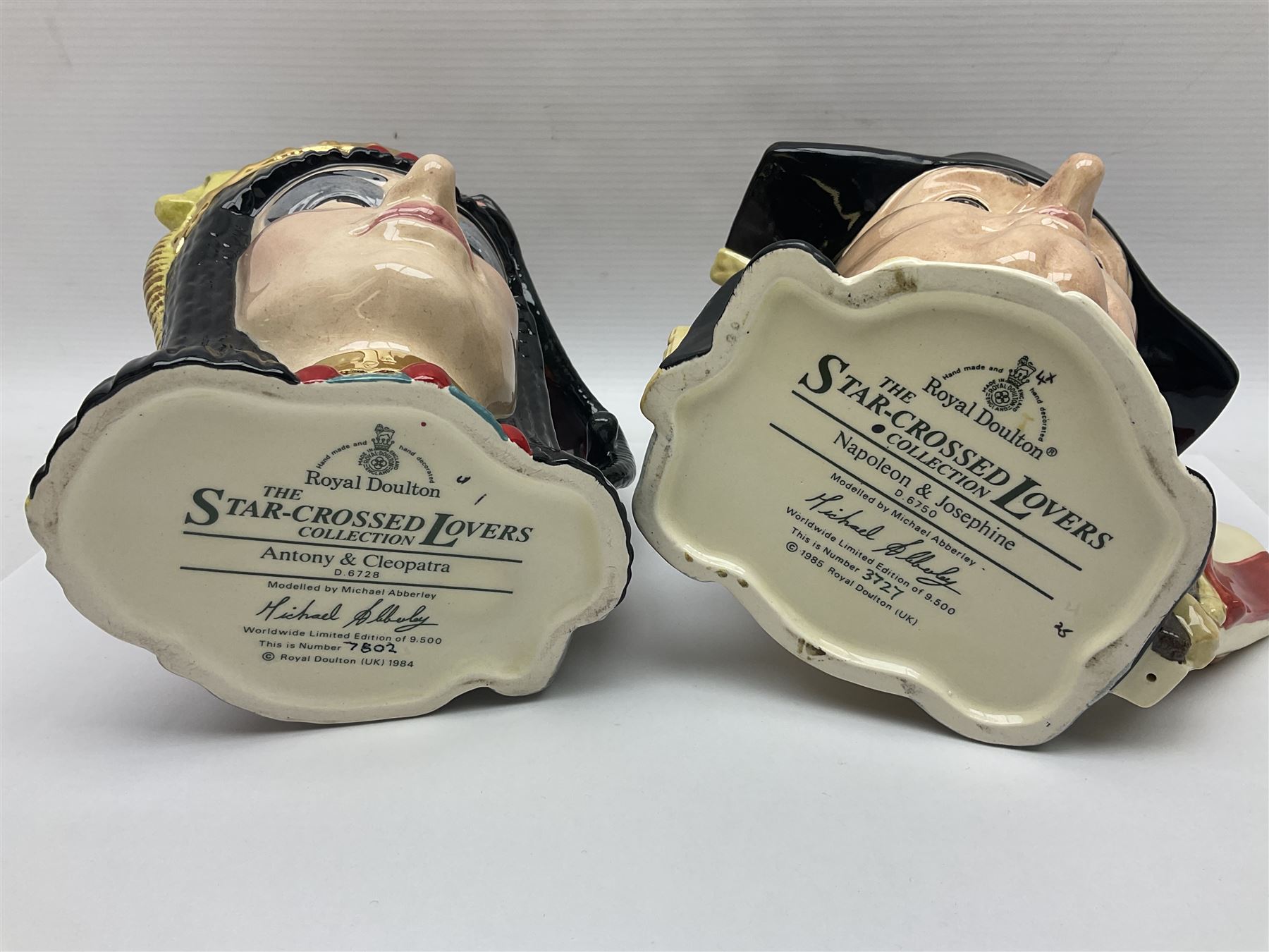 Royal Doulton two character jugs from the Star Crossed Lovers Collection, Antony & Cleopatra D6728 and Napoleon & Josephine D6750, together with two Royal Doulton Figures Micawber and Sairey Gamp