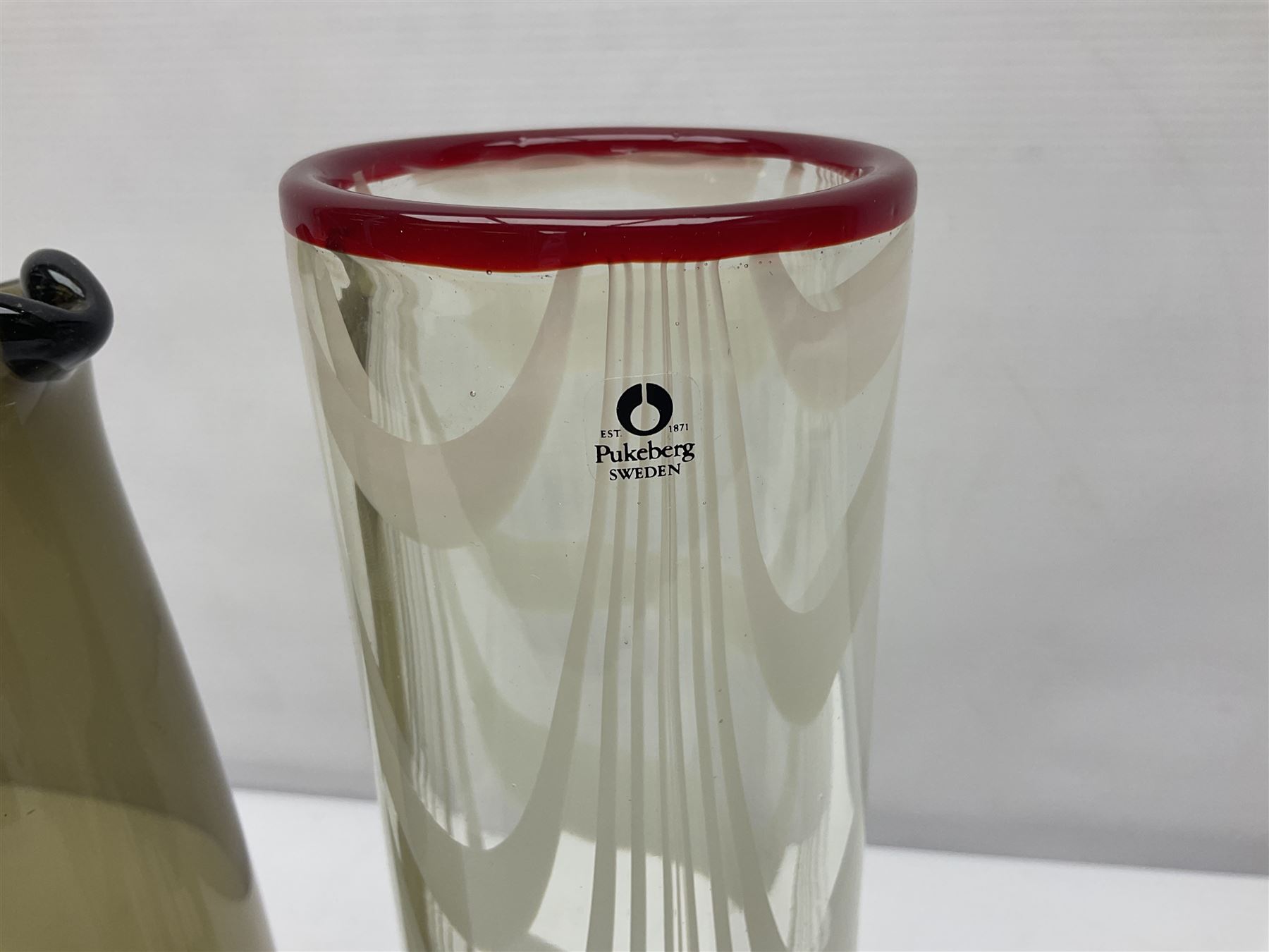 Two Whitefriars glass jugs, together with a Swedish Pukeberg art glass vase and three art glass bowls, including large pink example, some signed to base, tallest H30.5cm