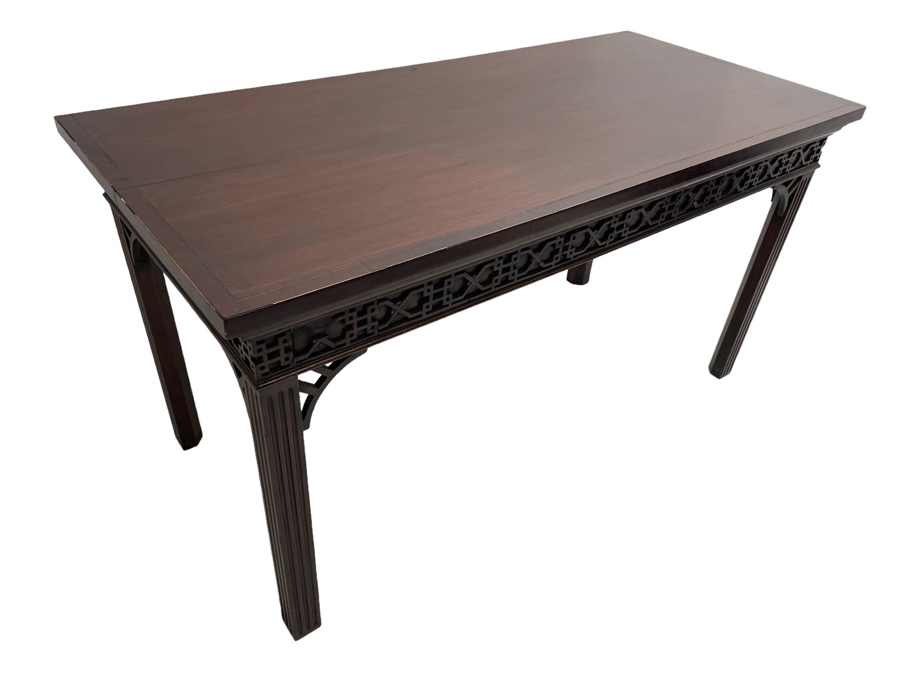 In the manner of Thomas Chippendale - early 19th century mahogany serving table, rectangular crossbanded top with boxwood stringing, the frieze with upper moulding over applied geometric fretwork, the left-hand side fitted with slide, on fluted square supports with inner chamfer 