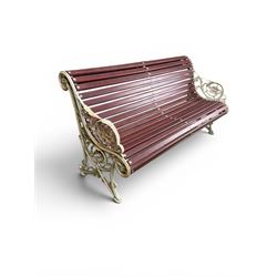 Large late Victorian cast iron garden bench, serpentine form with scroll back and seat, slatted with mahogany stained Sapele