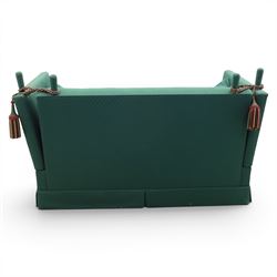 Late 20th century two-seat Knole sofa, covered in green woven fabric with lattice pattern, high panelled back and hinged drop arms secured by braided cords, loose cushioned seat and back with additional scatter cushions, on plinth base