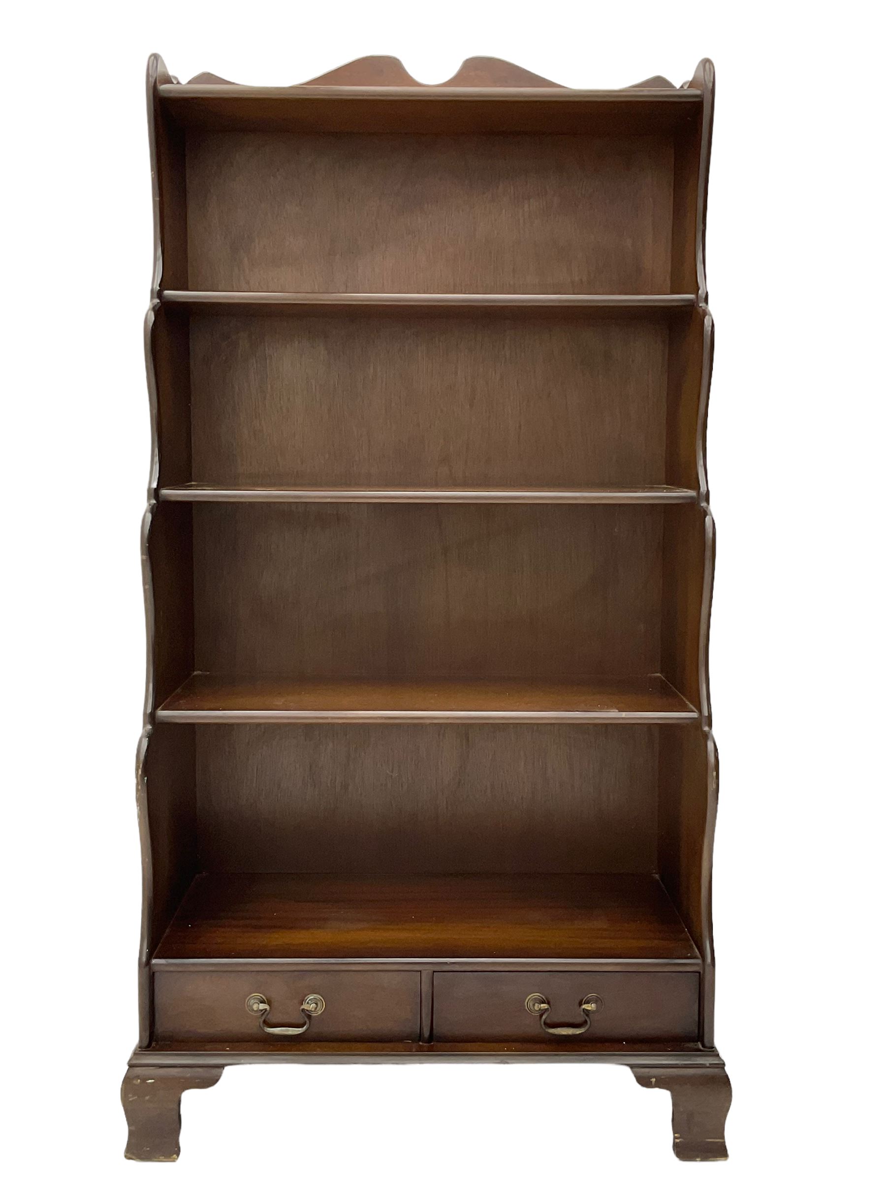 Late 20th century mahogany waterfall bookcase, fitted with two drawers, on bracket feet