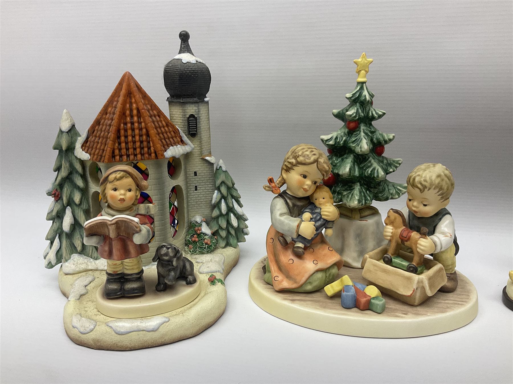Eight Christmas Hummel figures by Goebel, to include Wintertime Chapel candle holder, Winter Fun, Christmas Morning, Christmas Time and Gingerbread Lane, tallest H21cm