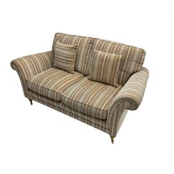 Parker Knoll - 'Burghley' two seat sofa upholstered in pale stripe fabric, raised on turned front supports with brass castors