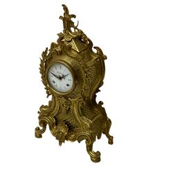 A 20th century Italian striking mantle clock in a brass case in the late 18th century Rocco style, with an enamel dial with Roman numerals and decorative pierced hands, with an 8-day floating balance movement striking the hours and half hours on twin bells.

