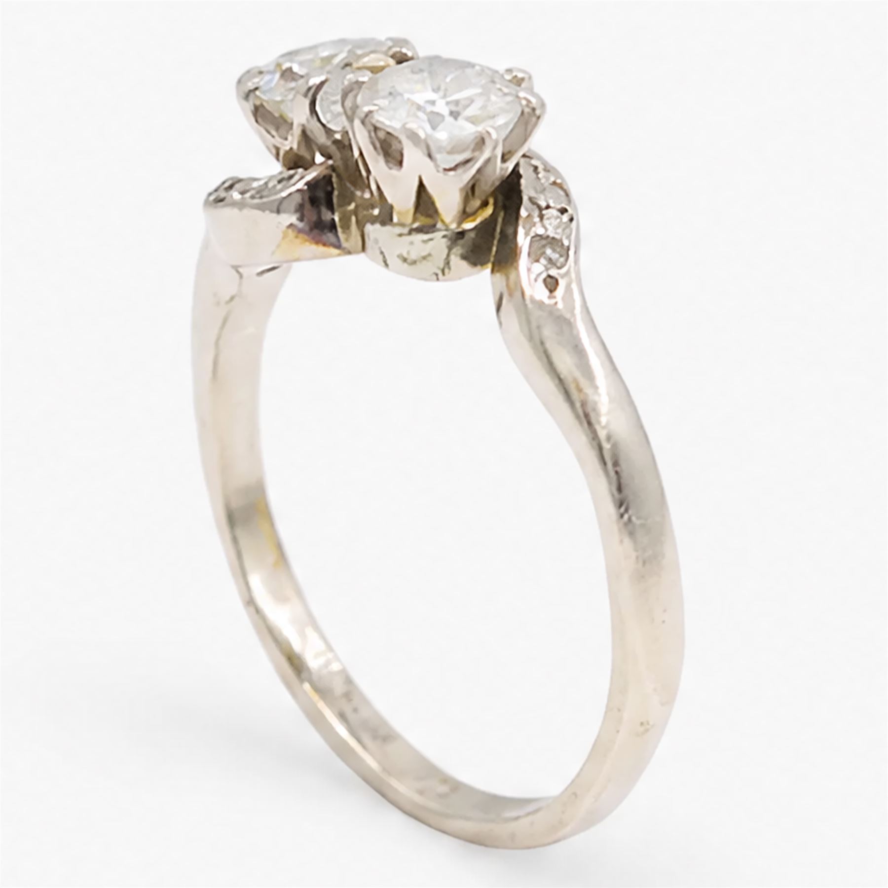 Platinum diamond crossover ring, set with two round brilliant cut diamonds and diamond set shoulders, stamped, total diamond weight approx 0.65 carat