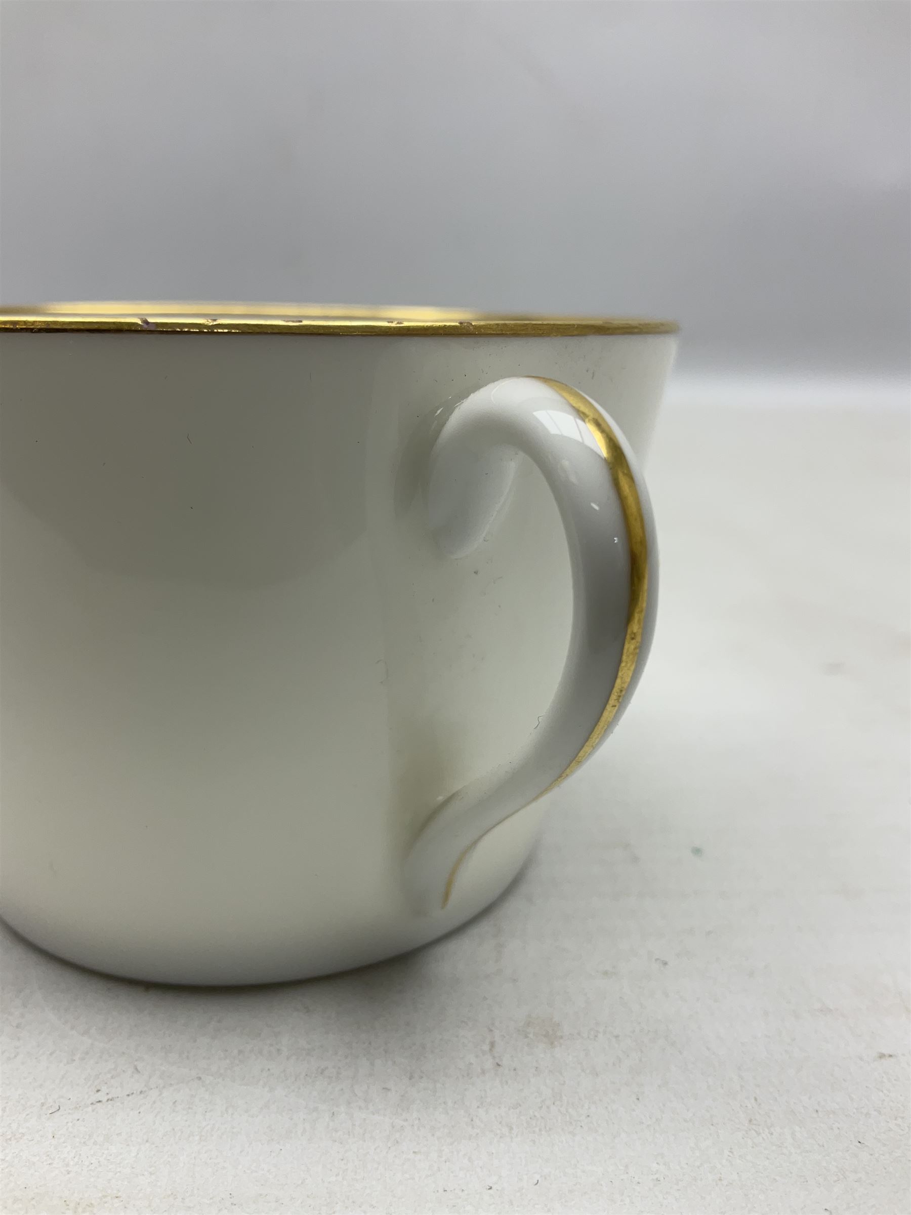 WW2 Nymphenburg cups and saucer, decorated with Imperial German Iron Cross encircled in a foliate boarder with gilt edging, with printed mark beneath 