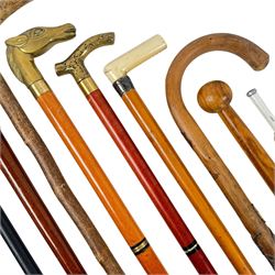 Collection of walking sticks, including two silver topped examples, hallmarked