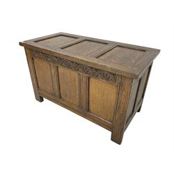 Mid-20th century panelled oak blanket box, triple panel lid and front, the frieze rail carved with lunettes, moulded rails and stile supports