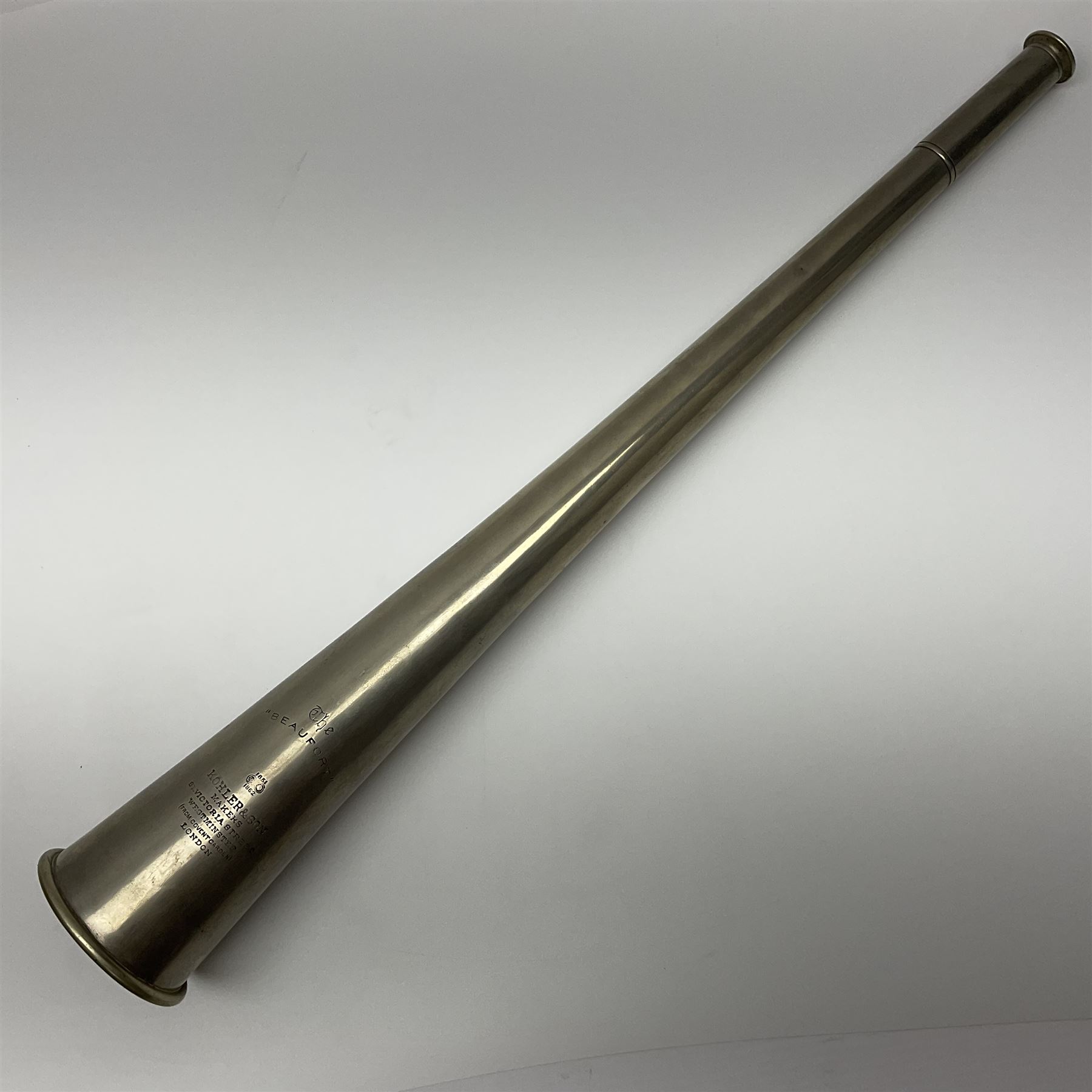 19th century telescopic hunting horn, the bell engraved 'The Beaufort', with makers mark Kohler & Son, makers, 61 Victoria Street, Westminster (from Covent garden) London, in a leather sheath, horn full extended L91cm 