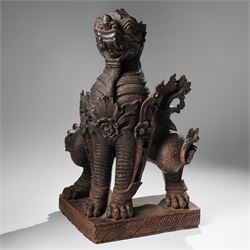 Burmese carved temple guardian figure, depicted seated with carved flame details, H52cm 