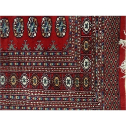  Bokhara red ground rug, geometric pattern field, repeating border, 244cm x 155cm  