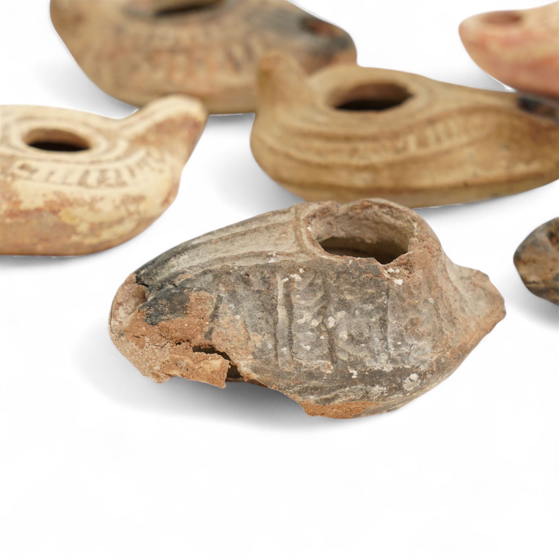 Antiquities; six Byzantine oil lamps, including terracotta examples, approximately 5th-7th century, having incised decoration, largest W10cm (6)