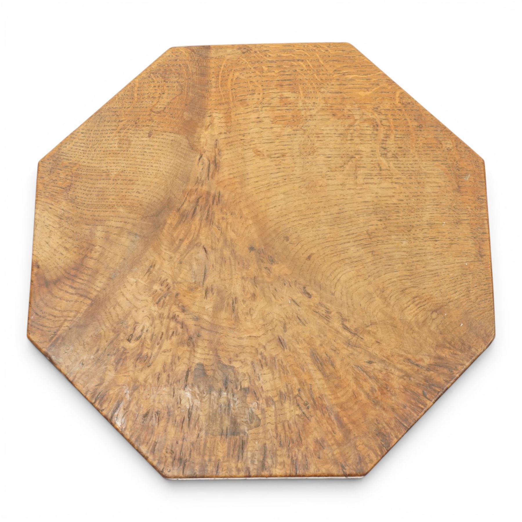 Mouseman - early 20th century adzed and figured burr oak coffee table of small proportions, the octagonal lightly adzed burr top raised on cruciform base and sledge feet, carved with tall mouse signature, by the workshop of Robert Thompson of Kilburn 