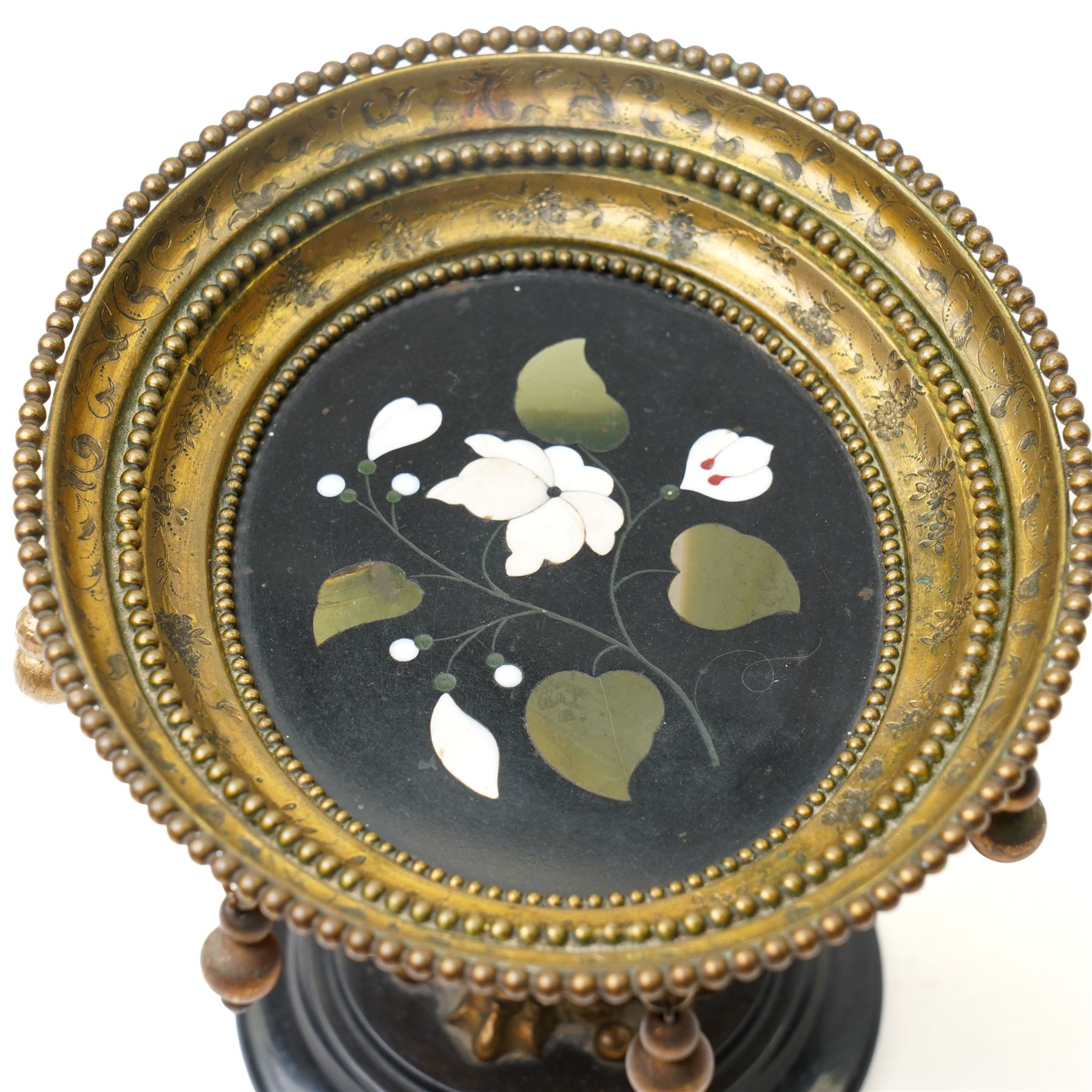 Italian Grand Tour pietra dura and ormolu tazza, the circular black stone top inlaid with a marble floral spray, within a beaded and foliate-cast ormolu rim hung with pendant spheres, on a scroll and acanthus-cast support and turned base, Florence, late 19th century, W15.5cm H12cm