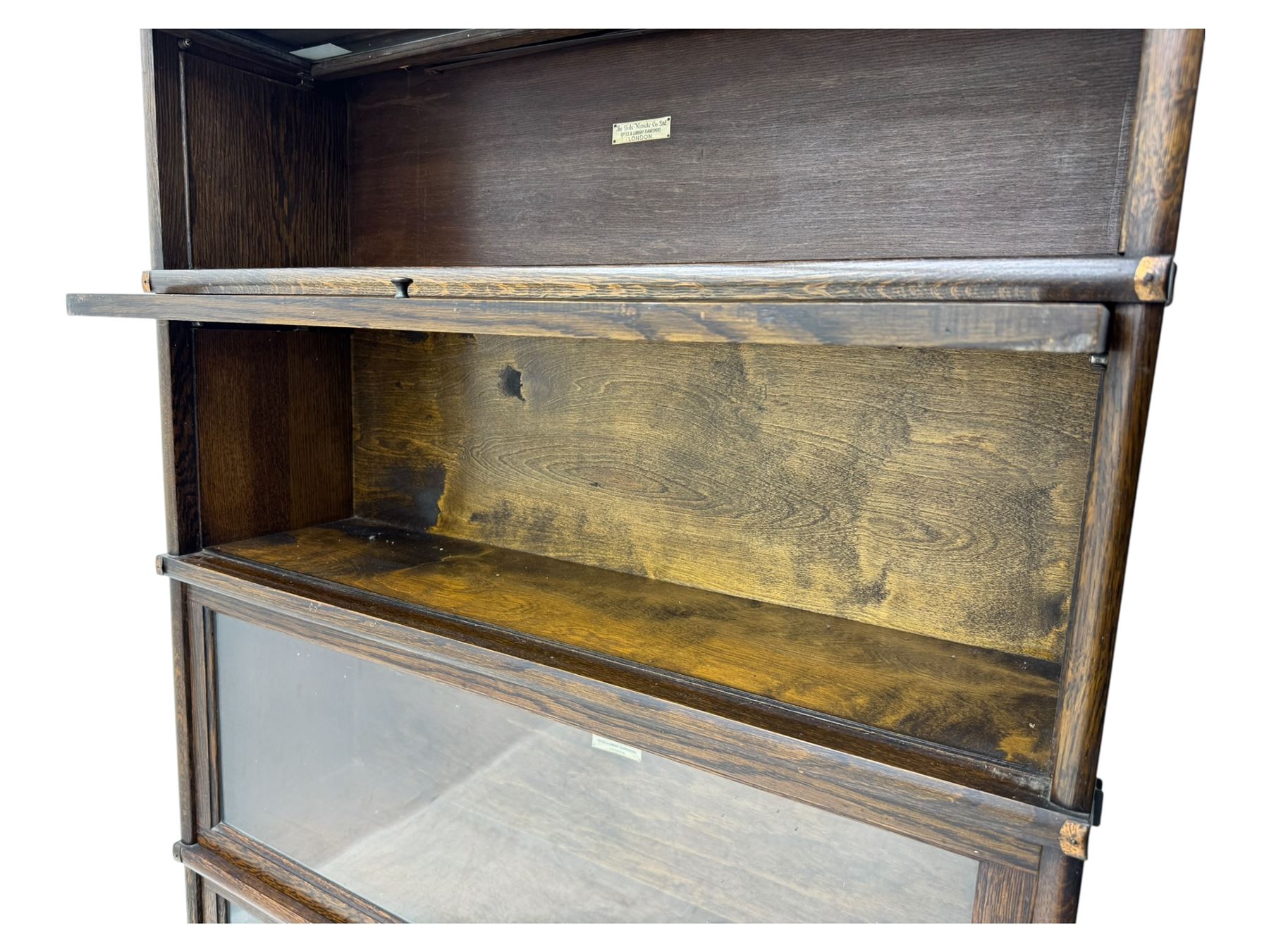 Globe Wernicke - stacking sectional library bookcase, over four glazed up-and-over doors, each bearing original makers mark, on moulded plinth base with inbuilt drawer