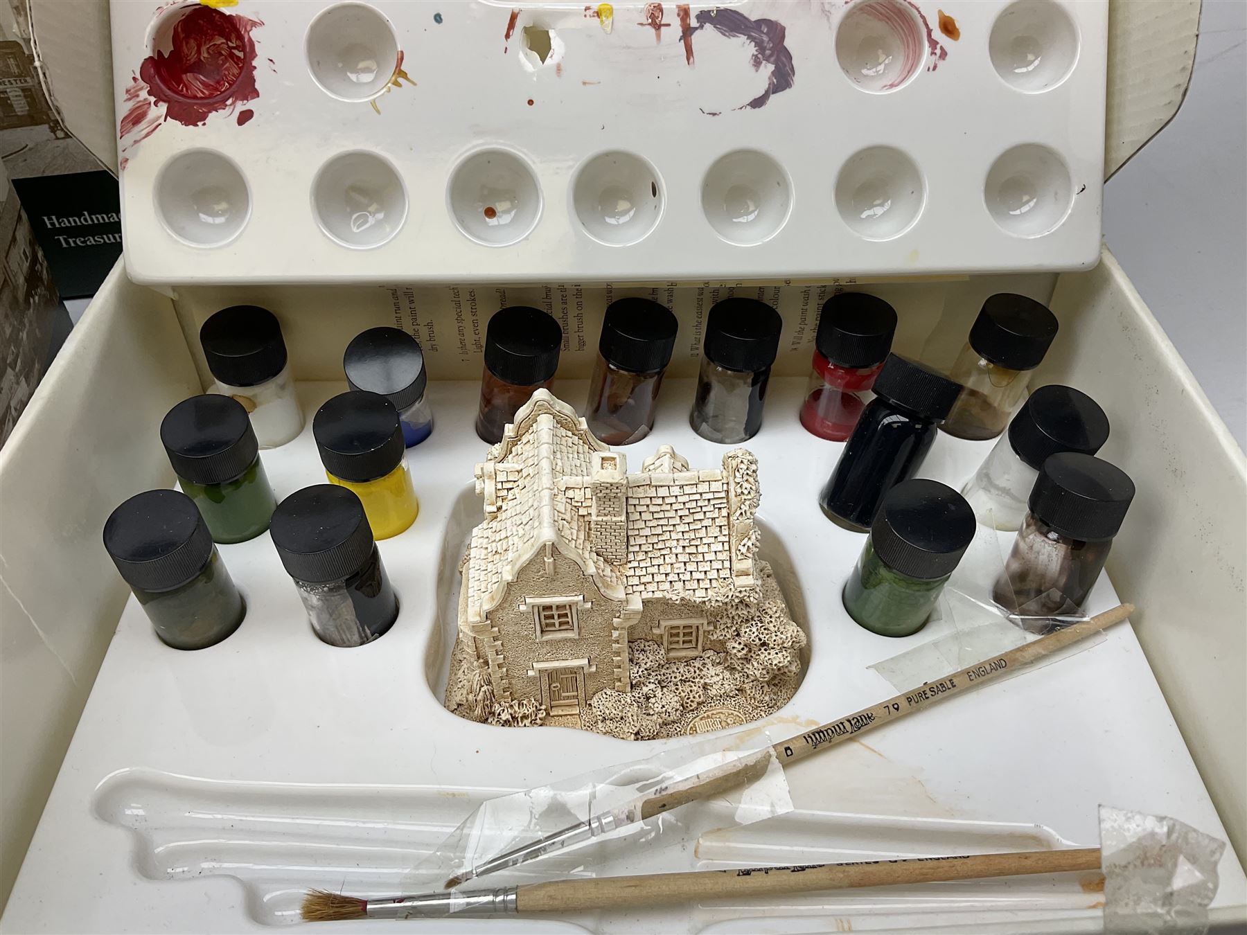 Ten Lilliput Lane models from the 'Paint Your Own' collection, to include cottages and plaques, all boxed, to include one boxed model with paints and brushes and a further box of paints