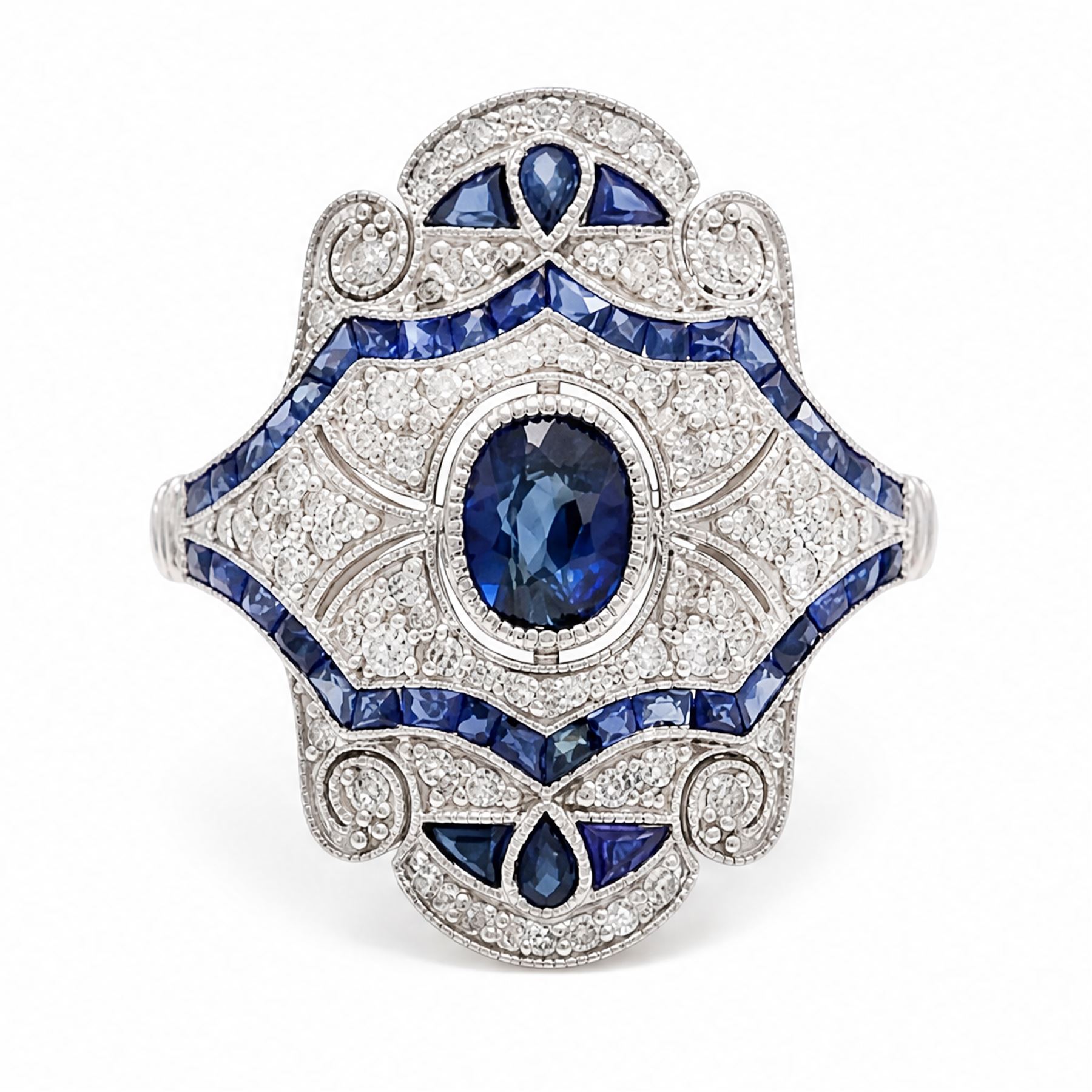 Platinum sapphire and diamond dress ring, milgrain set with a single oval cut sapphire, surrounded by single cut diamonds, calibre and vari-cut sapphires, in an pierced design setting, stamped PT 950, total sapphire weight 0.87 carat, total diamond weight 0.45 carat