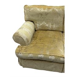 Contemporary two-seat sofa, upholstered in damask fabric with a pale gold floral pattern, rolled arms with covers, loose back and seat cushions, on matching skirted base with concealed castors