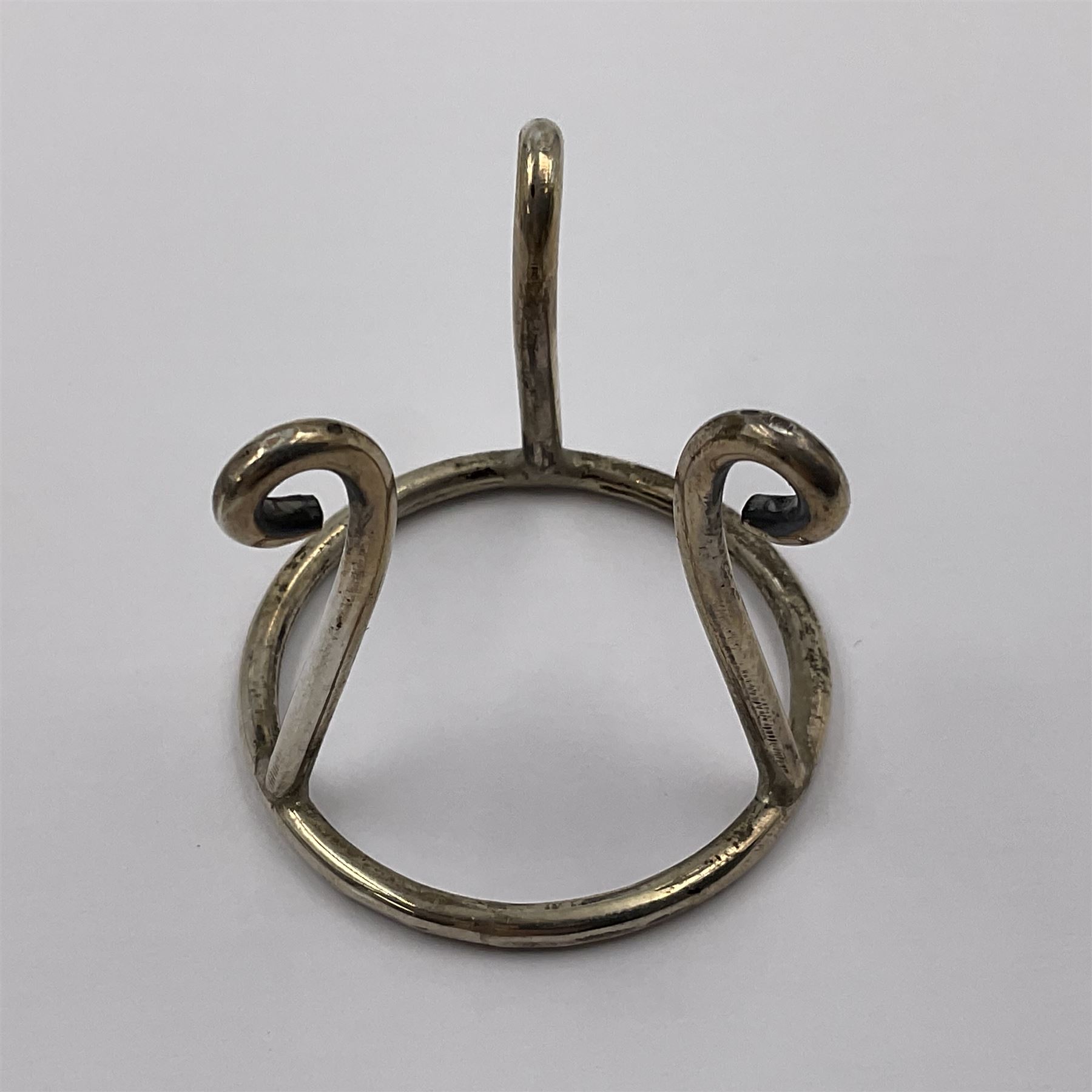 Modern silver limited edition Easter egg, no. 70/500, the gilt openwork body decorated with daffodils and detachable cover with pierced circular panel set with a single faceted blue stone, opening to reveal a gilt interior, upon silver stand with three scrolling pad feet, each hallmarked St James House Company, London 1980, height including stand 8cm