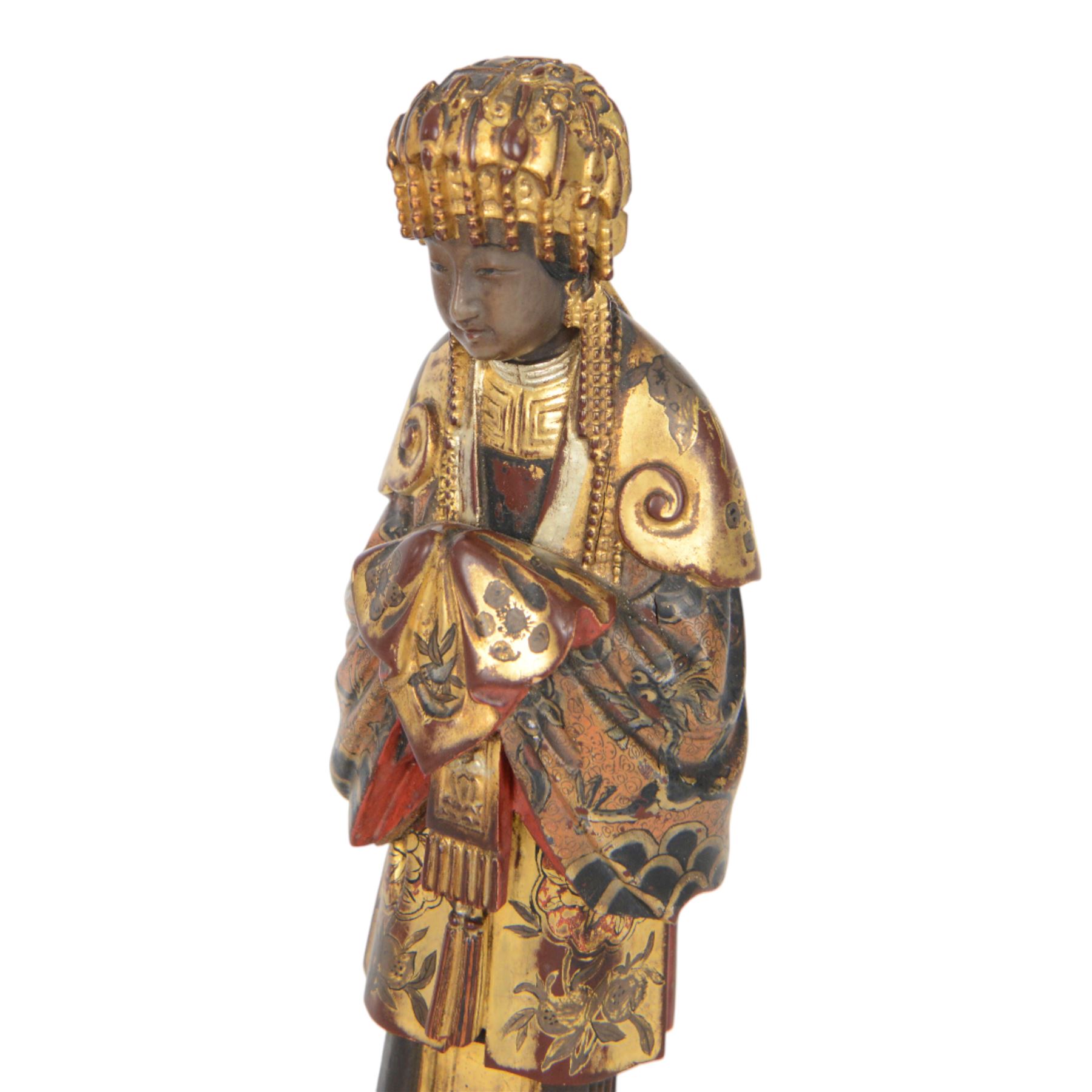 Pair of Asian carved wooden lacquered figures, in ceremonial dress, possibly wedding attire, highlighted throughout in gilt, H22cm