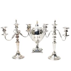 Silver plated two handled vase shape tea urn with mother of pearl acorn lift on shaped sup...