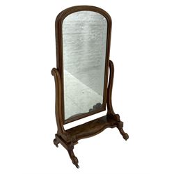 Victorian mahogany cheval dressing mirror, arched mirror in moulded frame, serpentine supports on shaped platform, on splayed feet with ceramic castors