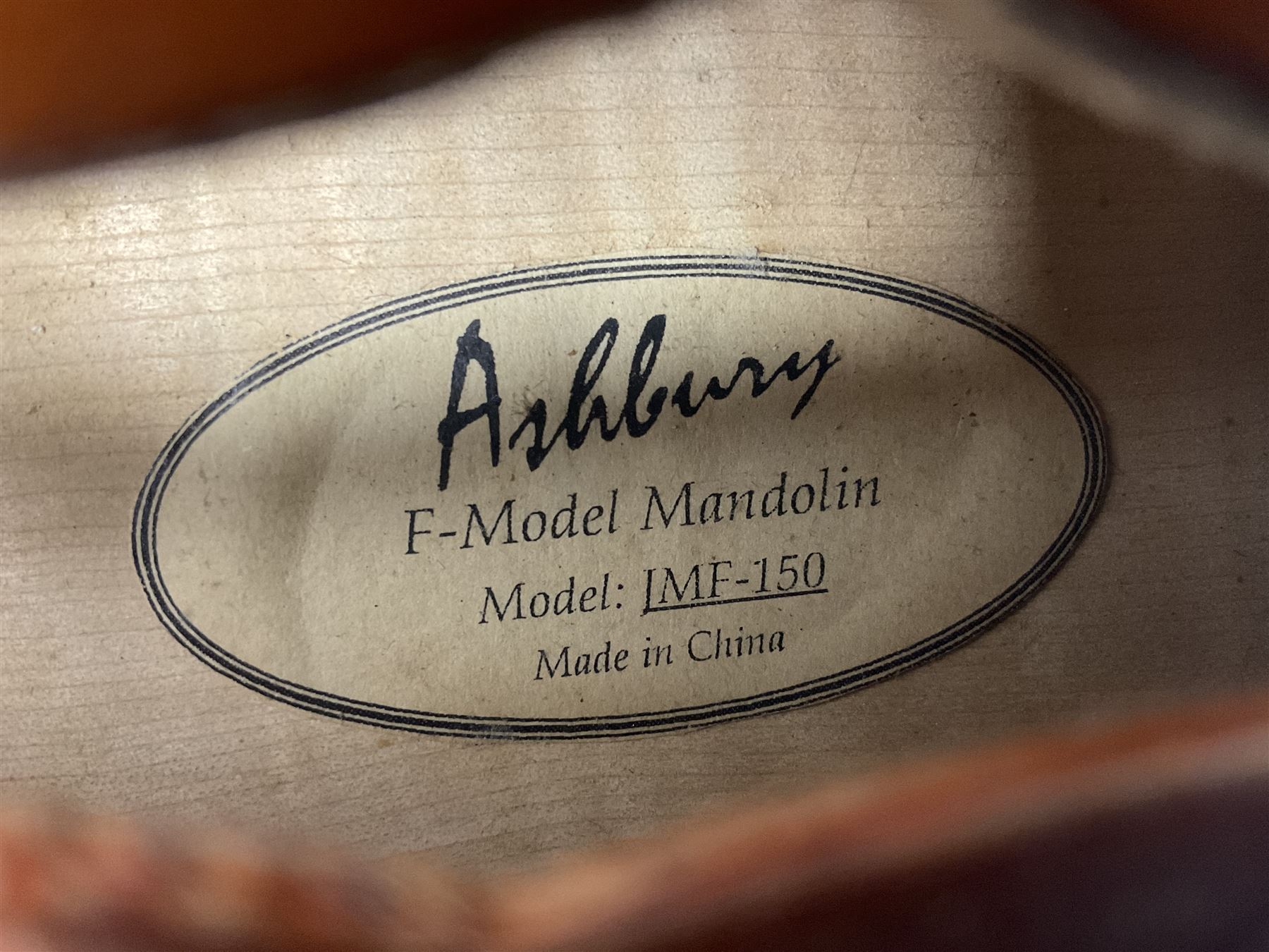 Ashbury F-Model eight-string mandolin, model no.IMF-150 with two-piece maple back and ribs and sunburst top, mother-of-pearl inlay; bears maker's label; L69cm
