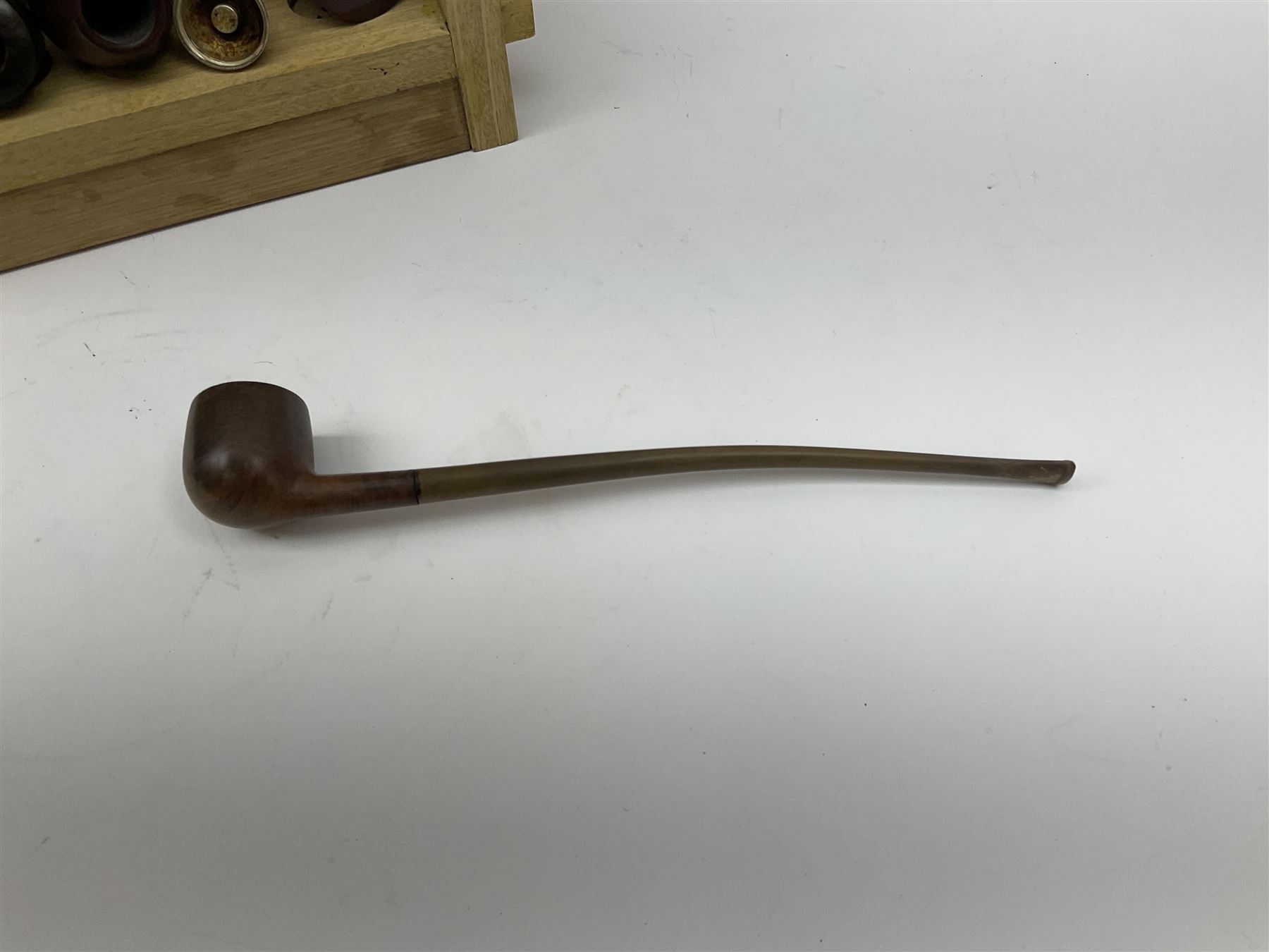 Pipes and two tiered wooden rack together with eleven pipers, including briar pipe carved as a wolf, Sea Dog straight pipe, John Brumfit pipe, meerschaum pipe ect, pipe rack H29.5cm