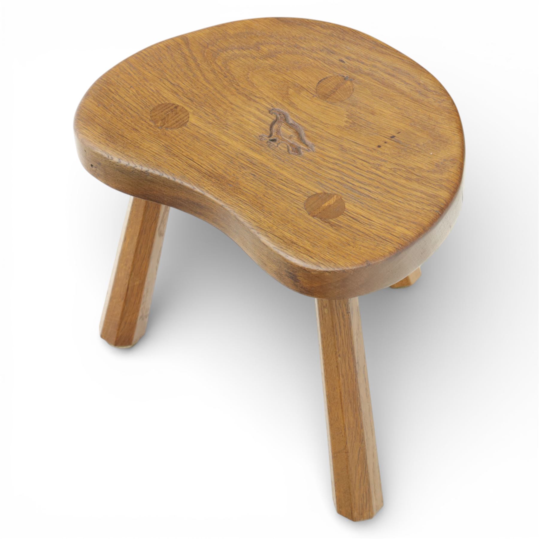 Eagleman - small oak calf stool, raised on three octagonal supports with signature Eagle motif to the seat from the workshop of Albert Jeffray, Sessay