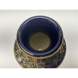 Early 20th century Japanese Satsuma vase, the body of baluster form decorated with two panels, the first depicting beauties with children in a garden, and the second depicting figures with mount Fuji in the distance, on navy blue ground with gilt foliate decoration, with iron red marks beneath, H19cm