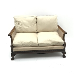  Early 20th century walnut two seat Bergere sofa, scrolled arms, acanthus carved cabriole leg with hairy paw feet, W134cm  
